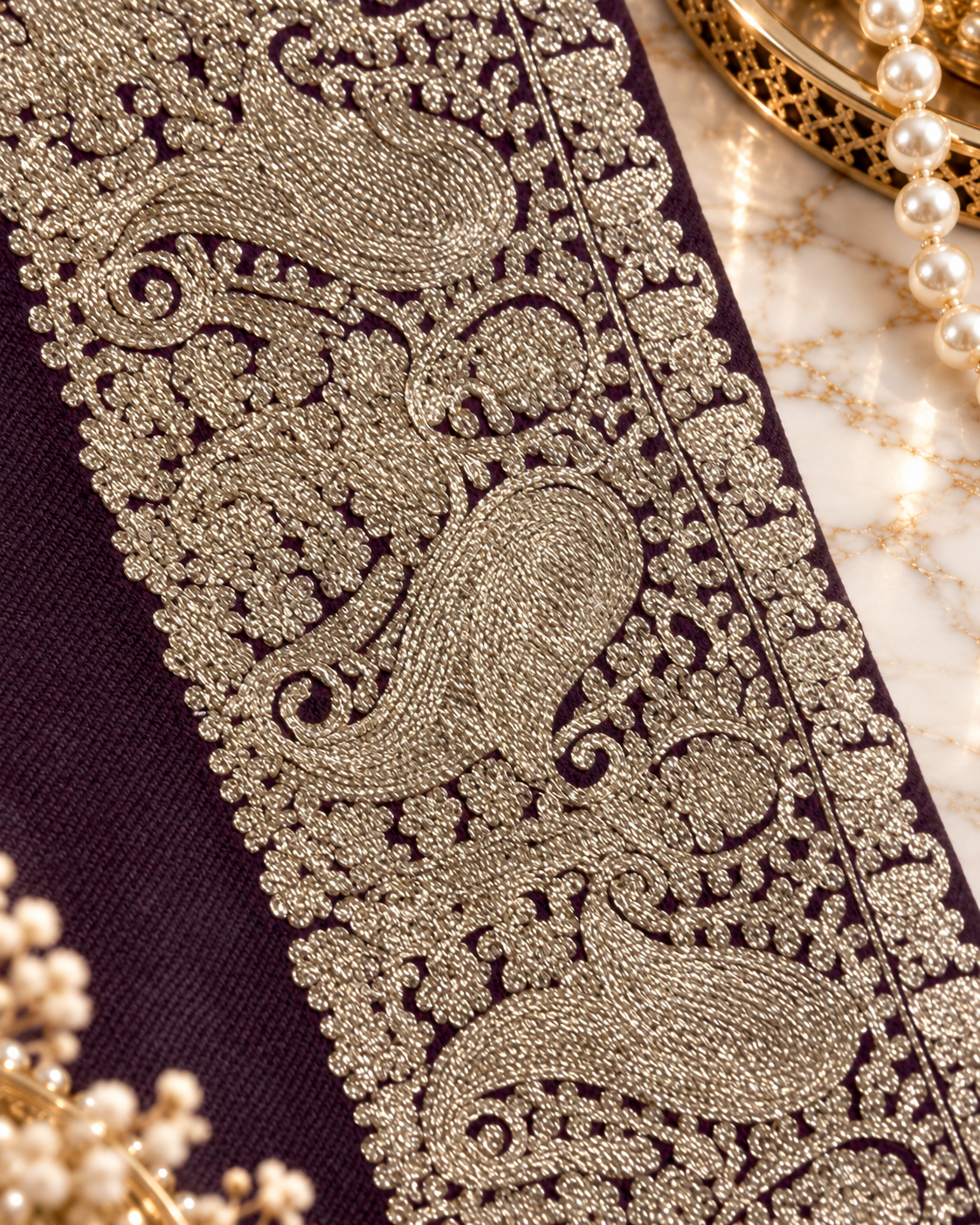 Champagne-coloured embroidery on the plum ground of Piece 018